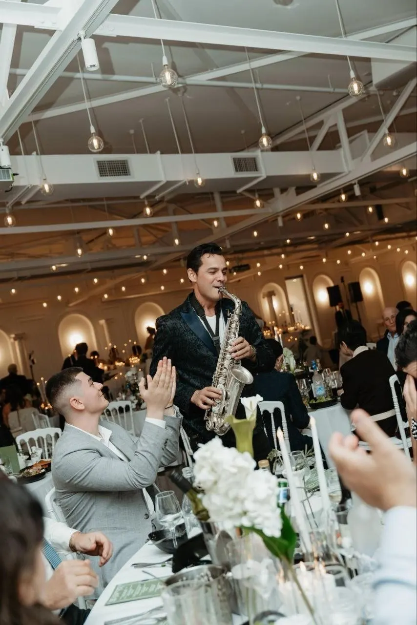 Orget Sax working the room table to table on a wireless mic